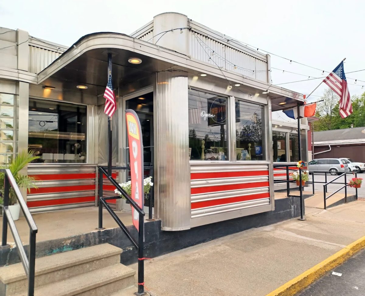 The stainless-steel Walton Diner on Delaware Street, with red stripes along the front and American flags by the entrance